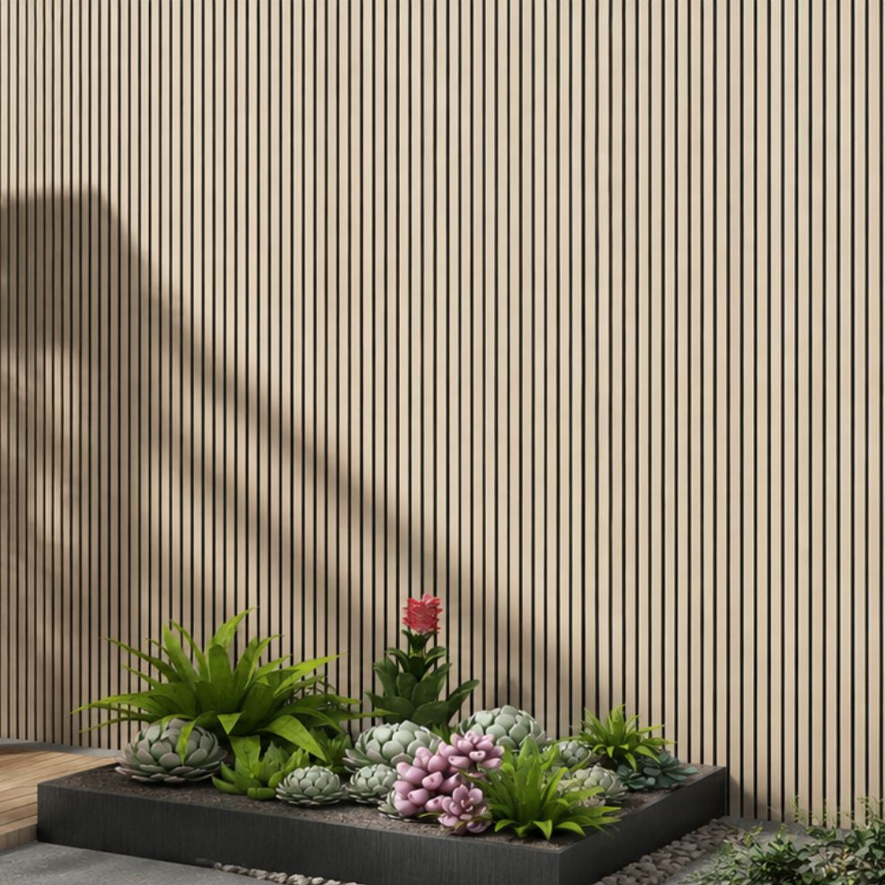 A modern garden planter box filled with various succulents and small green plants, including a pink flower, set against a beige slatted wooden wall.