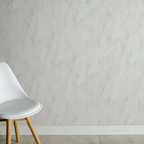 White chair against a light gray wall with a white baseboard_10mm Storm Grey Marble Gloss Shower Panel 1M x 2.4M
