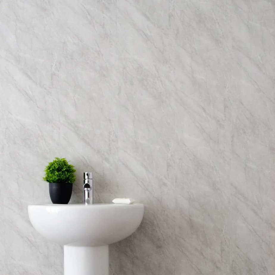 White pedestal sink with a small plant against a gray marble wall_10mm_Lightning_Marble_Gloss_Shower_Panel_1M_x_2.4M_8